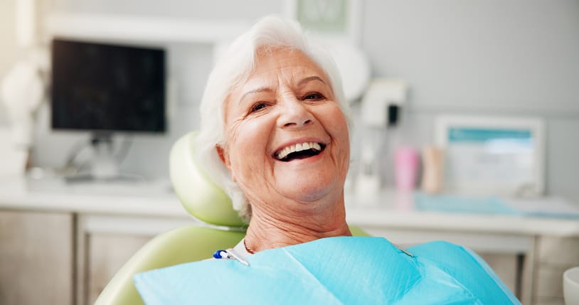 Portrait, smile and senior woman at dentist for teeth whitening results, dentures or oral hygiene. Healthcare, chair and elderly patient in clinic for root canal treatment, dental implants or filling